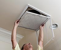 Advace HVAC echnician changing air filter